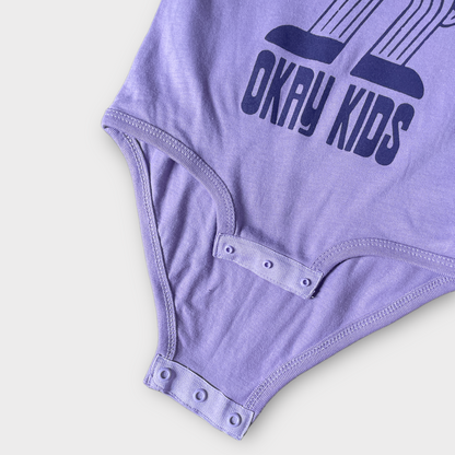 Okay Kids Logo Baby Bodysuit in Lavender