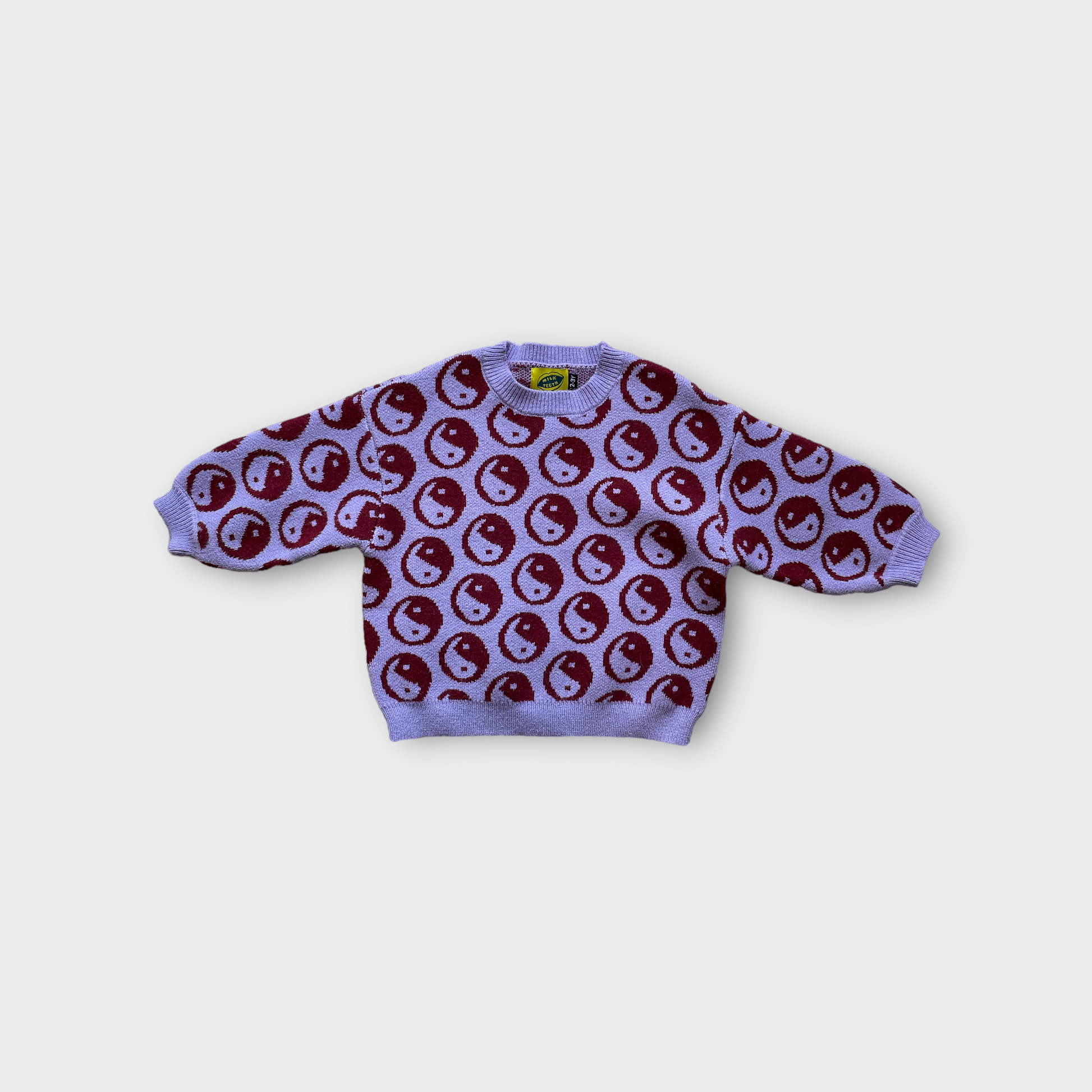 violet kids sweater covered with dark red ying yang symbols 